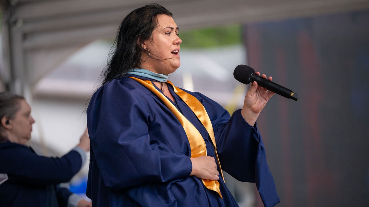 Anna Bond Hilbie sings the national anthem for graduates.