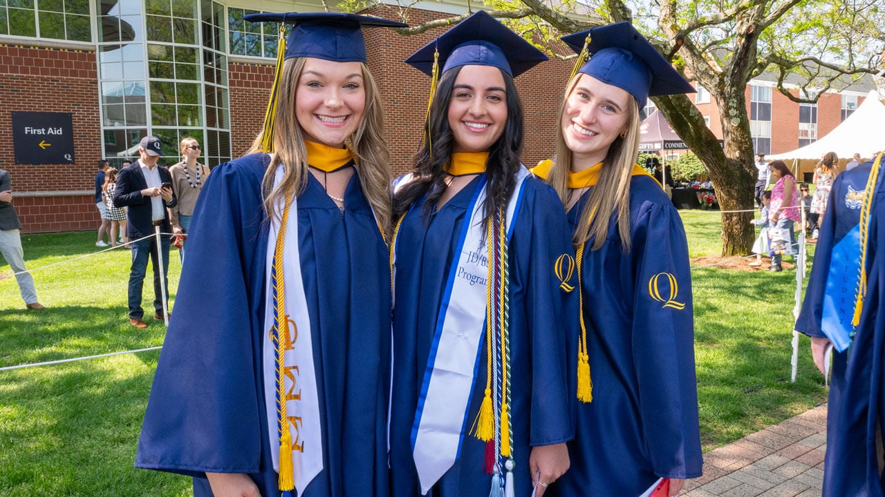 Graduates pose as they process into commencement.