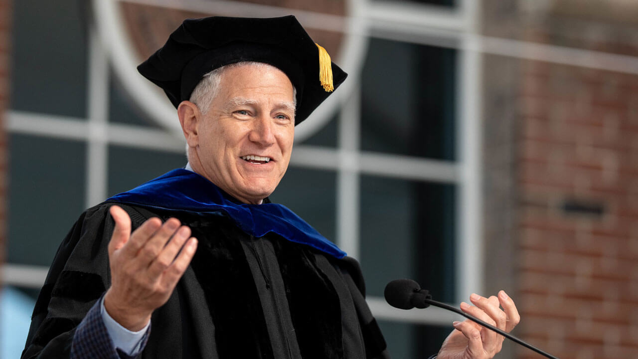 John Von Stein speaks at the podium on the Commencement stage