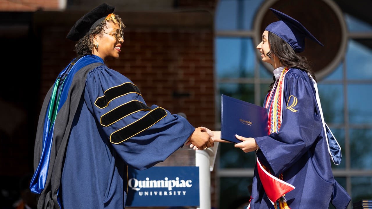 Graduate accepts diploma.
