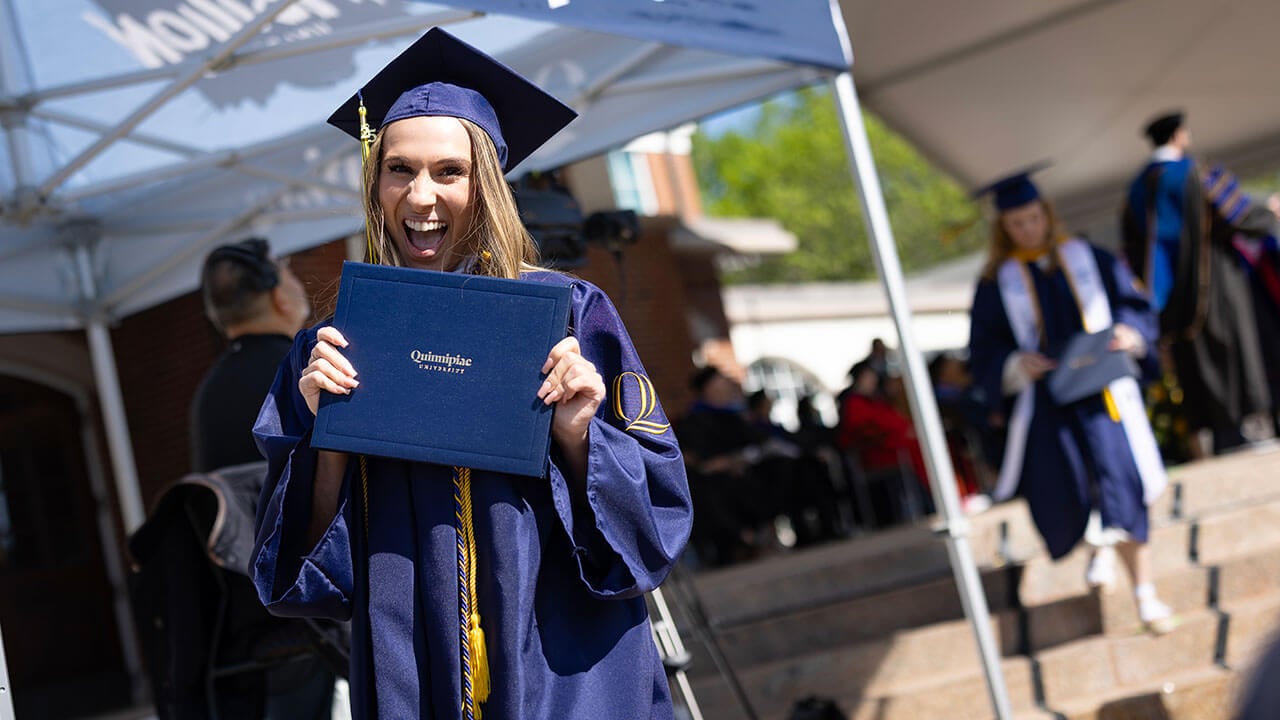 graduate grins with new diploma
