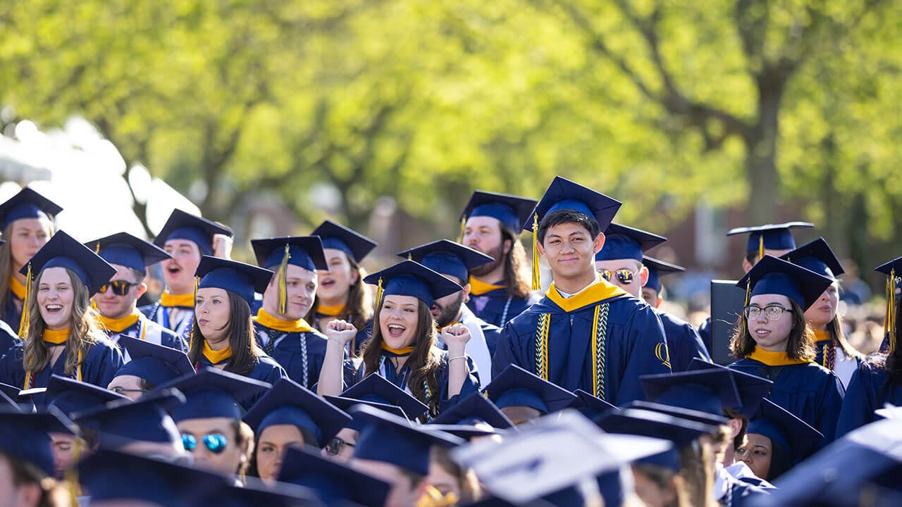 Graduates cheer in the crowd
