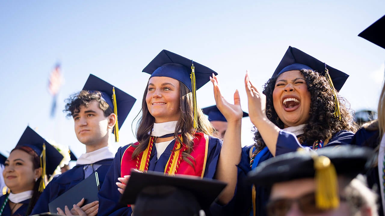 graduates smile together