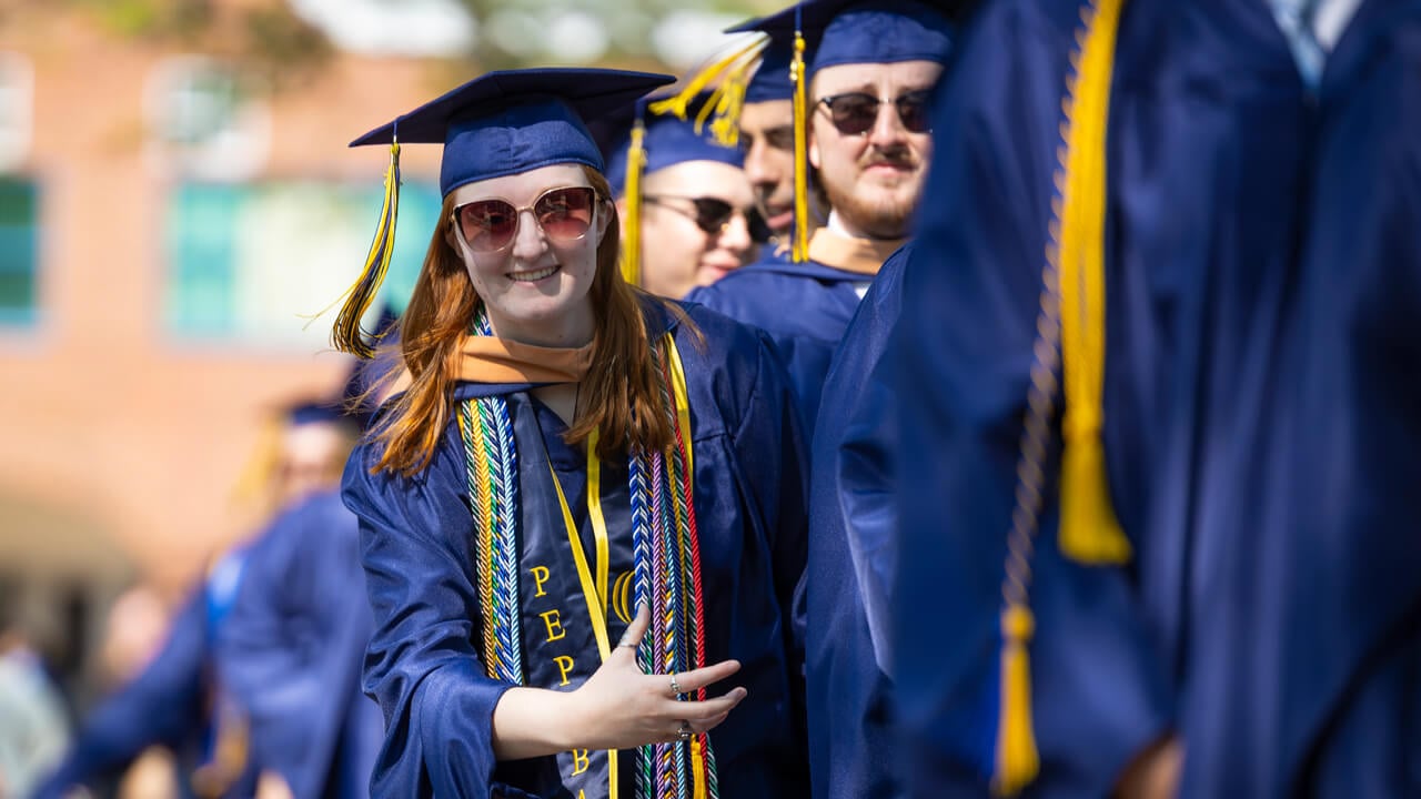 Lauren Jerram does the bobcat roar as she processes into commencement.