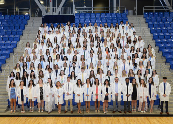 School of Nursing students smile together after the pinning ceremony