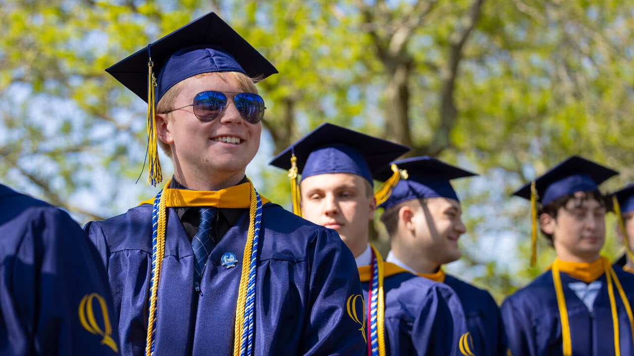 A grad smiling into the distance