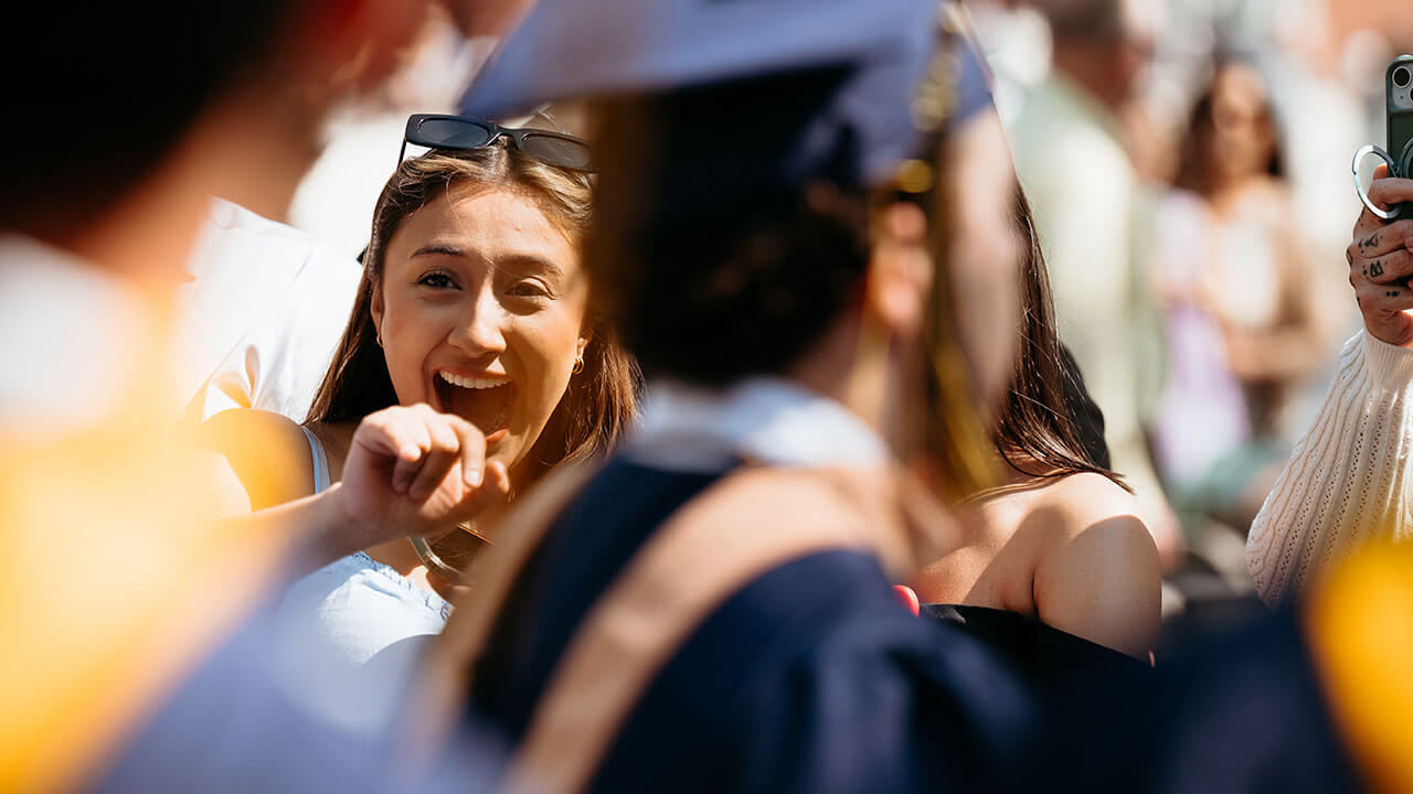 A family member waving at the graduate they know