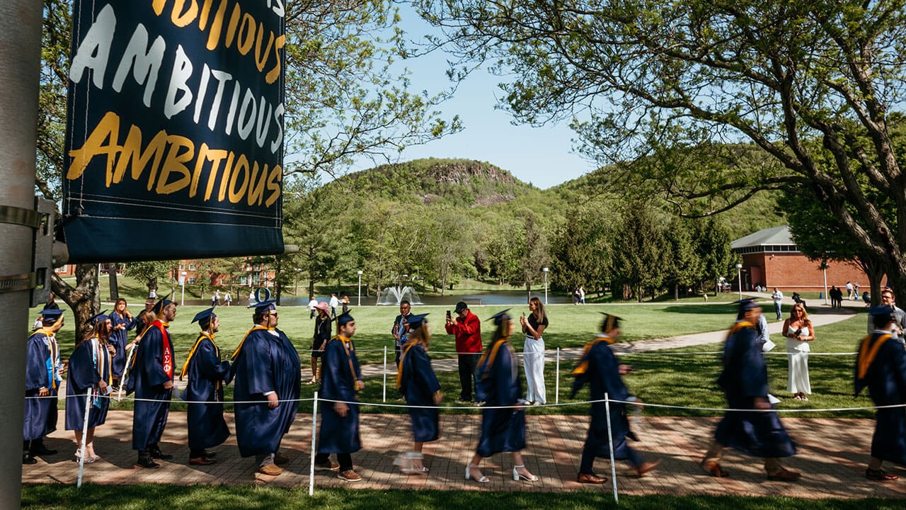 Graduates walking on the quad and blurred from the motion