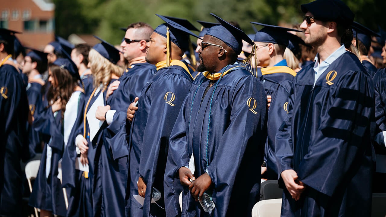 Graduates listening to the national anthem