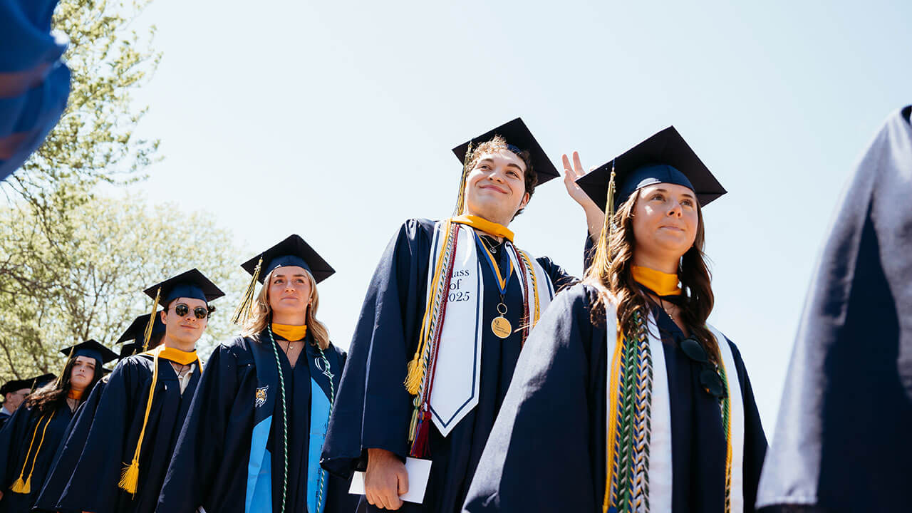 A graduate looking up and smiling