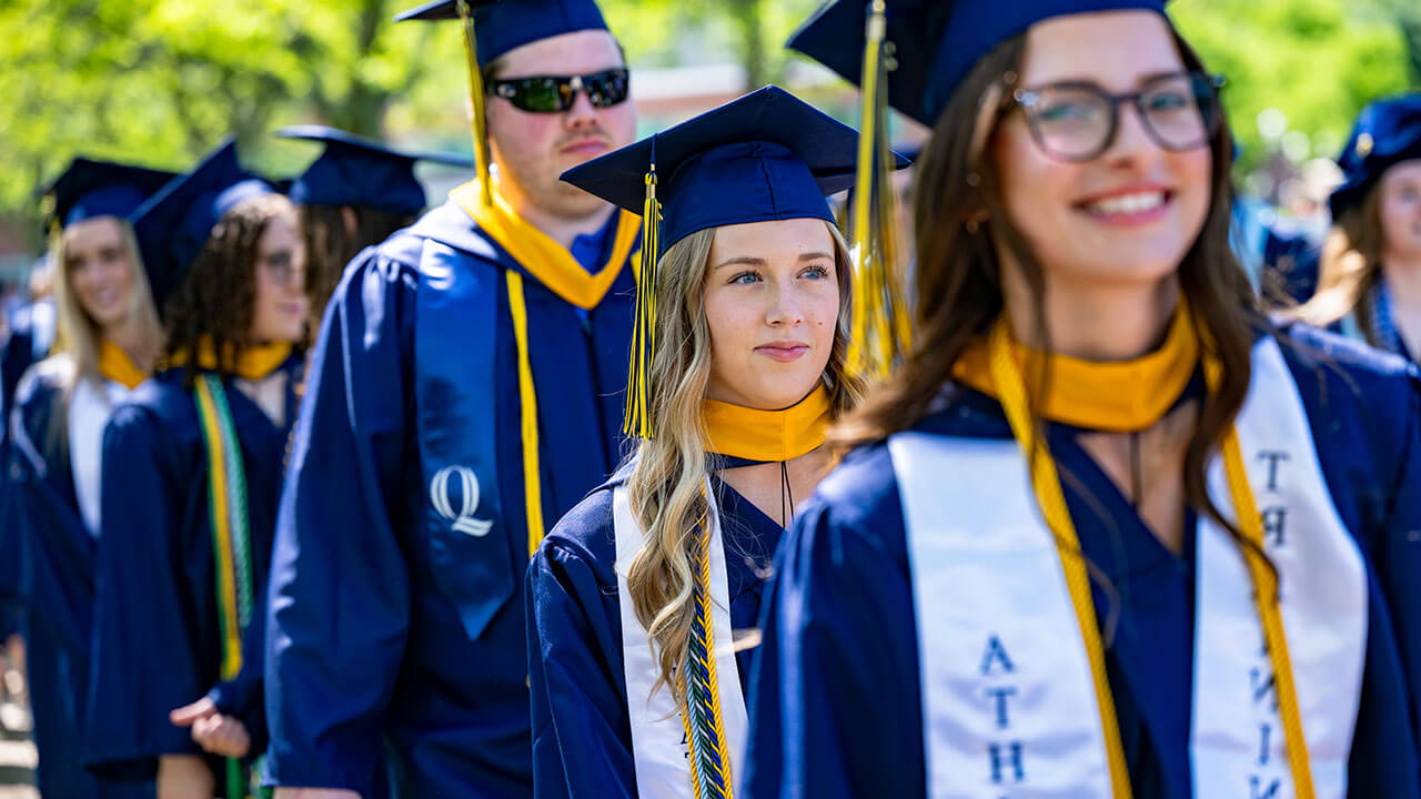 A focused graduate waking towards the library