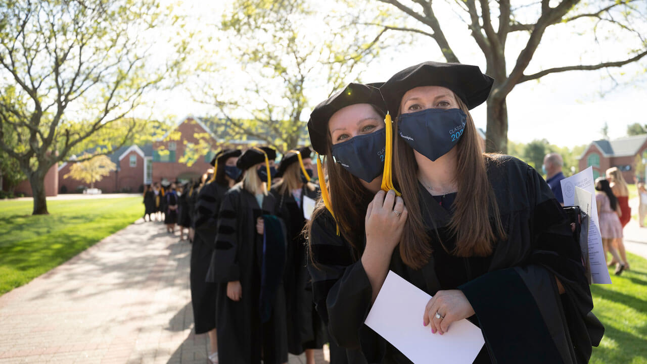 Graduates lined up posing for the camera before the ceremony