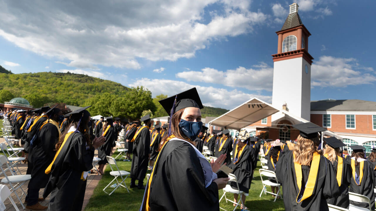 Graduates clapping at commencement ceremony