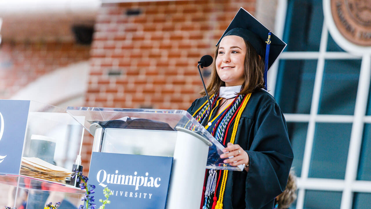 Elyssa Wrubel smiles at the podium on the library steps