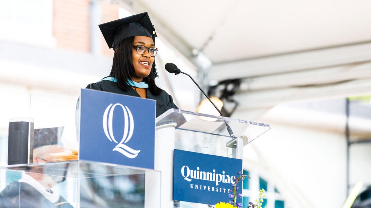 Cynthia Clement delivers a speech from the library steps