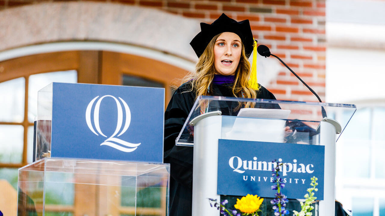 Nicholle Maille speaks to the crowd from the library steps
