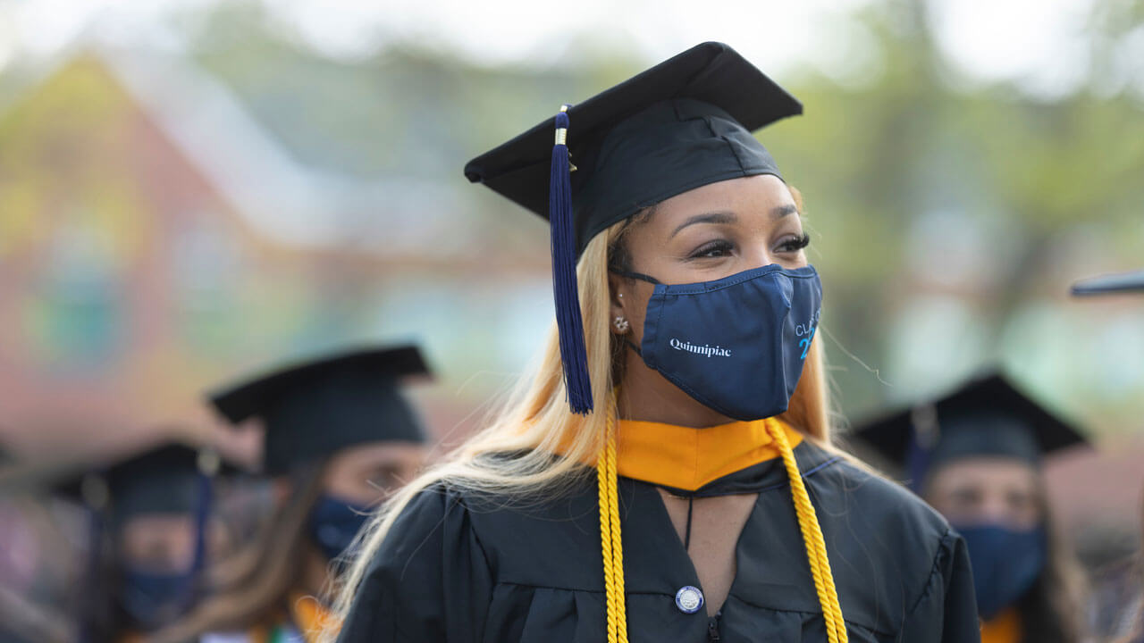 Graduate watching commencement ceremony