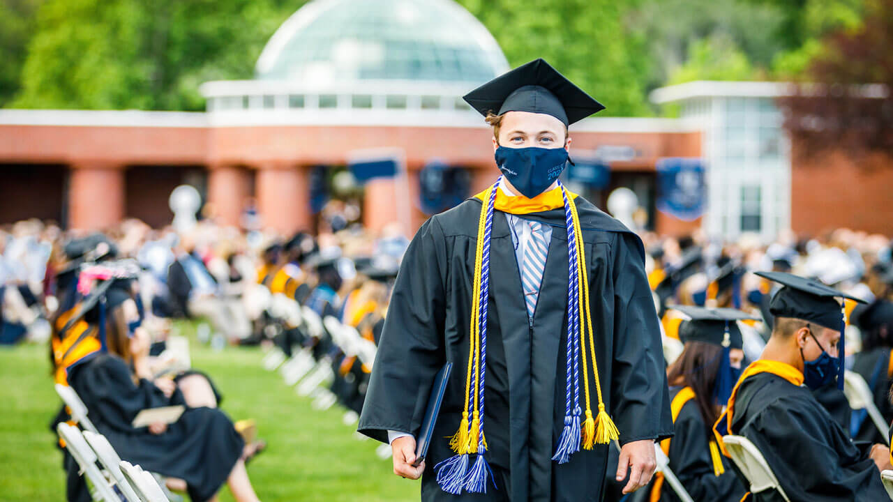 Nicholas Shiner walking with his diploma