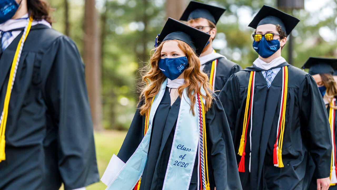 Graduates walking into commencement
