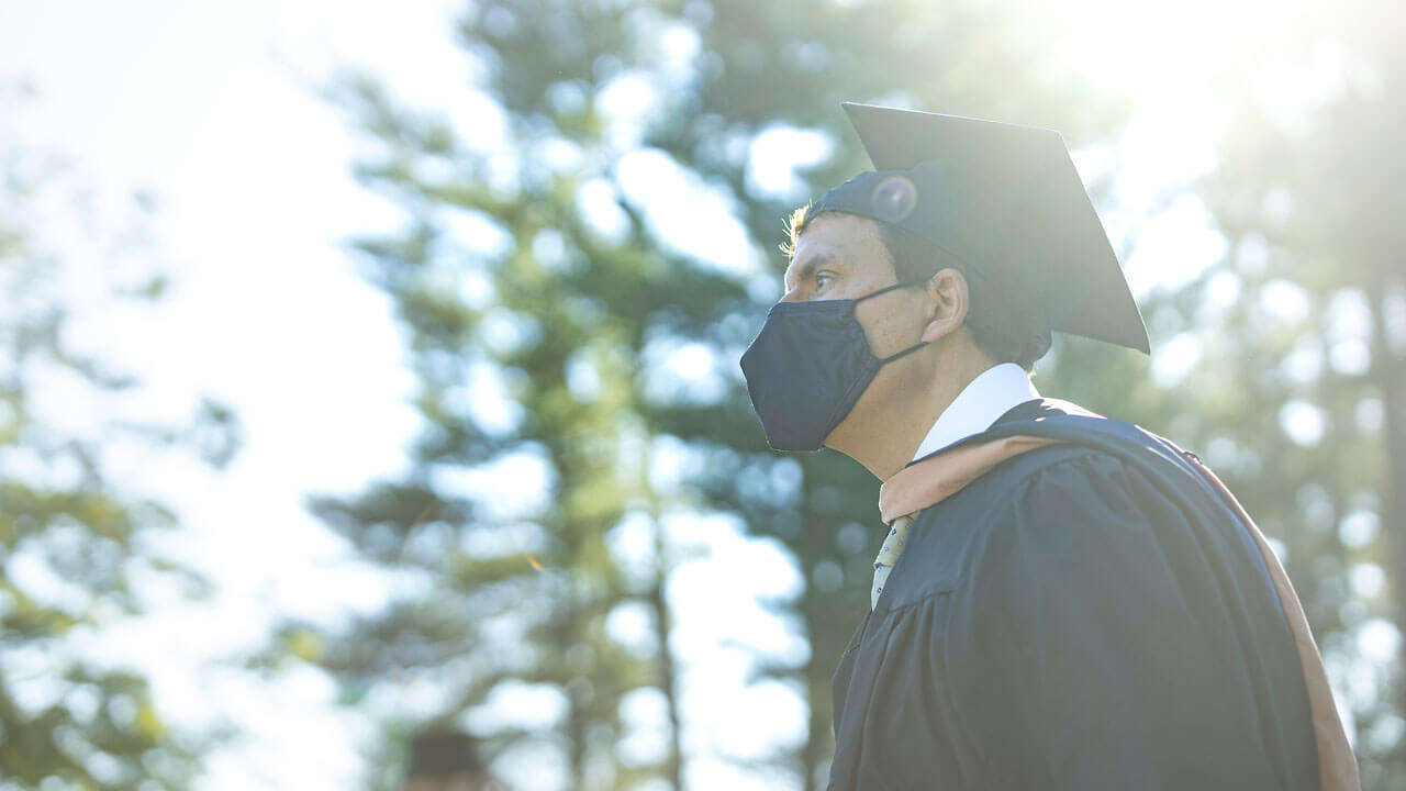 Person standing in the pine grove