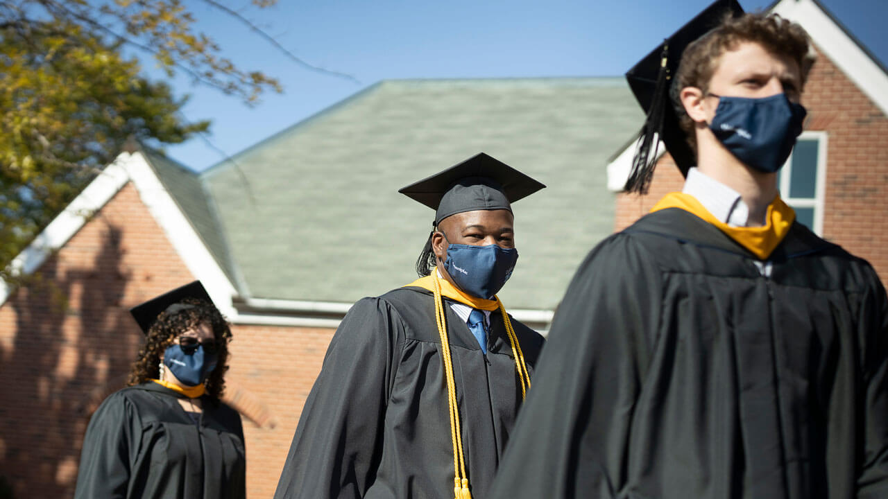 2020 graduates walking into commencement ceremony