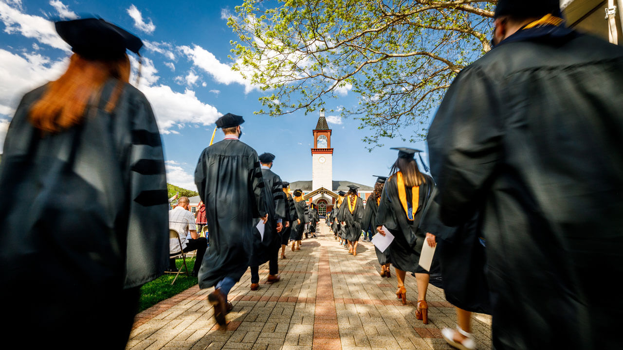 Graduates walking into their commencement ceremony