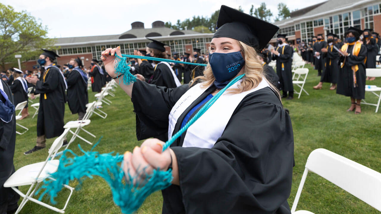 Graduate standing in the Quad during commencement