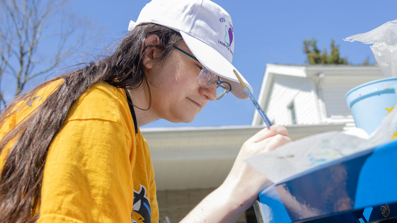 Quinnipiac Arbor Day volunteer painting rocks