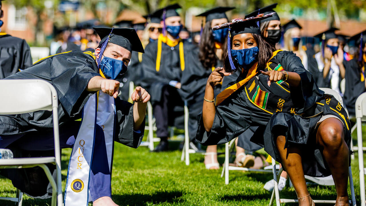 Graduates watching commencement ceremony
