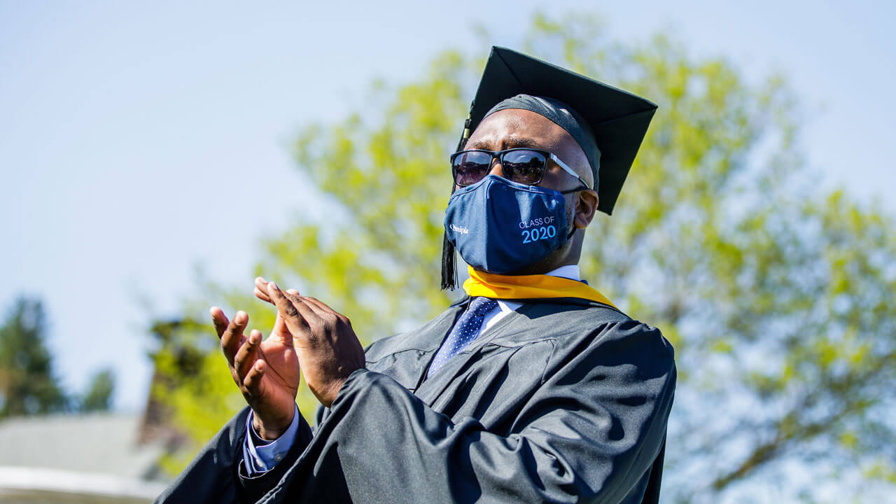 Graduate clapping at commencement ceremony