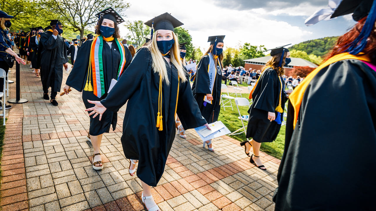 Graduates walking into commencement ceremony