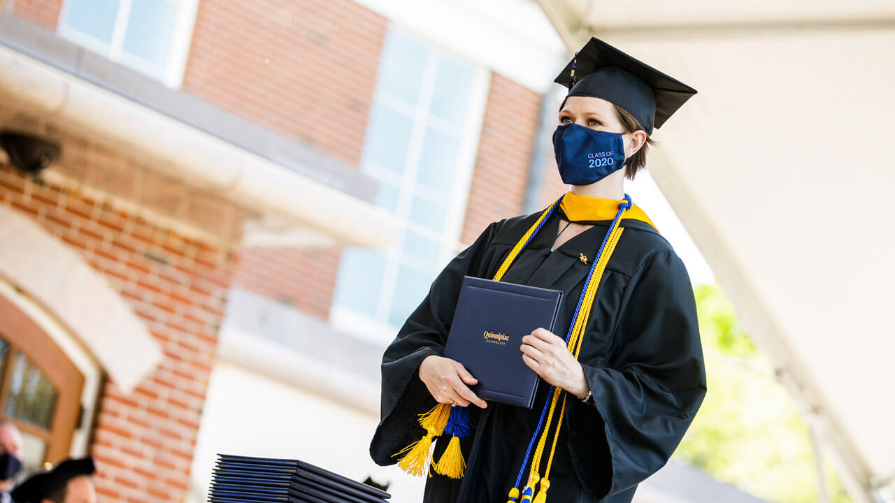 Graduate holding diploma