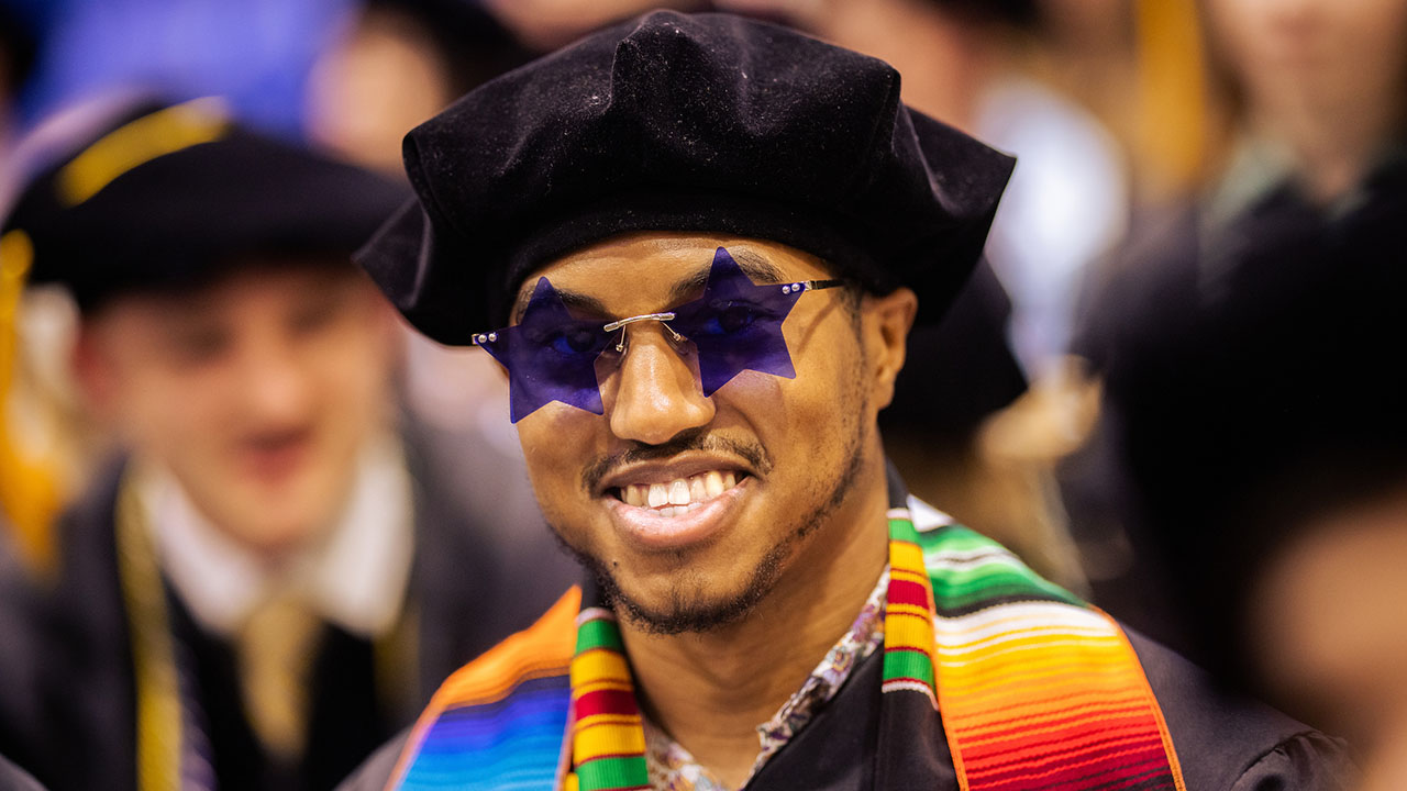 Graduate with star sunglasses on