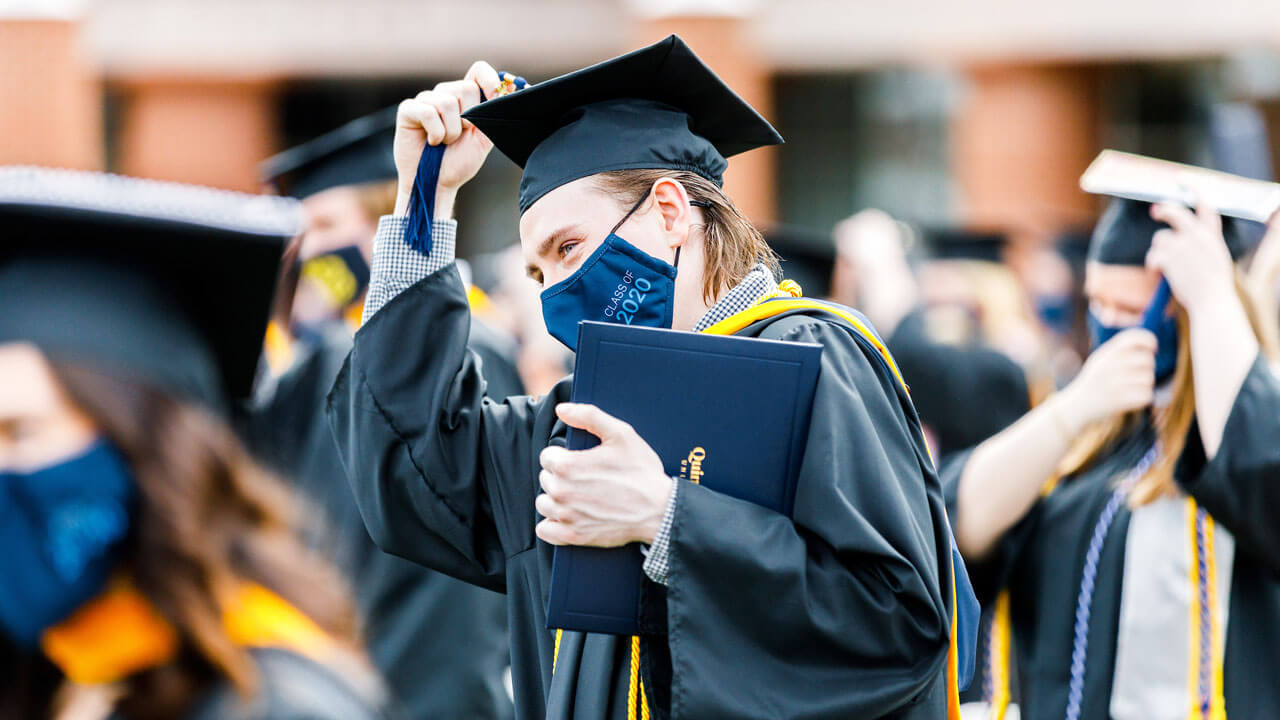 Graduate moving his tassel following the conferral of degrees