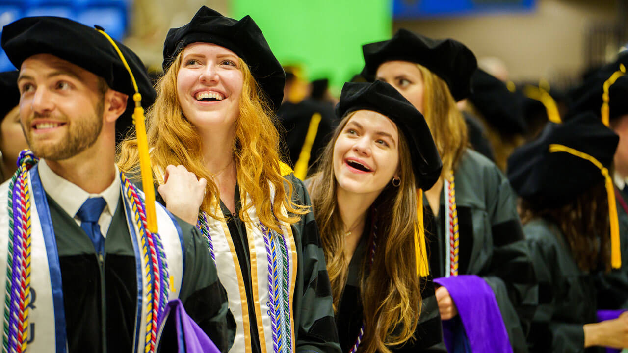 A group of graduating law students smile