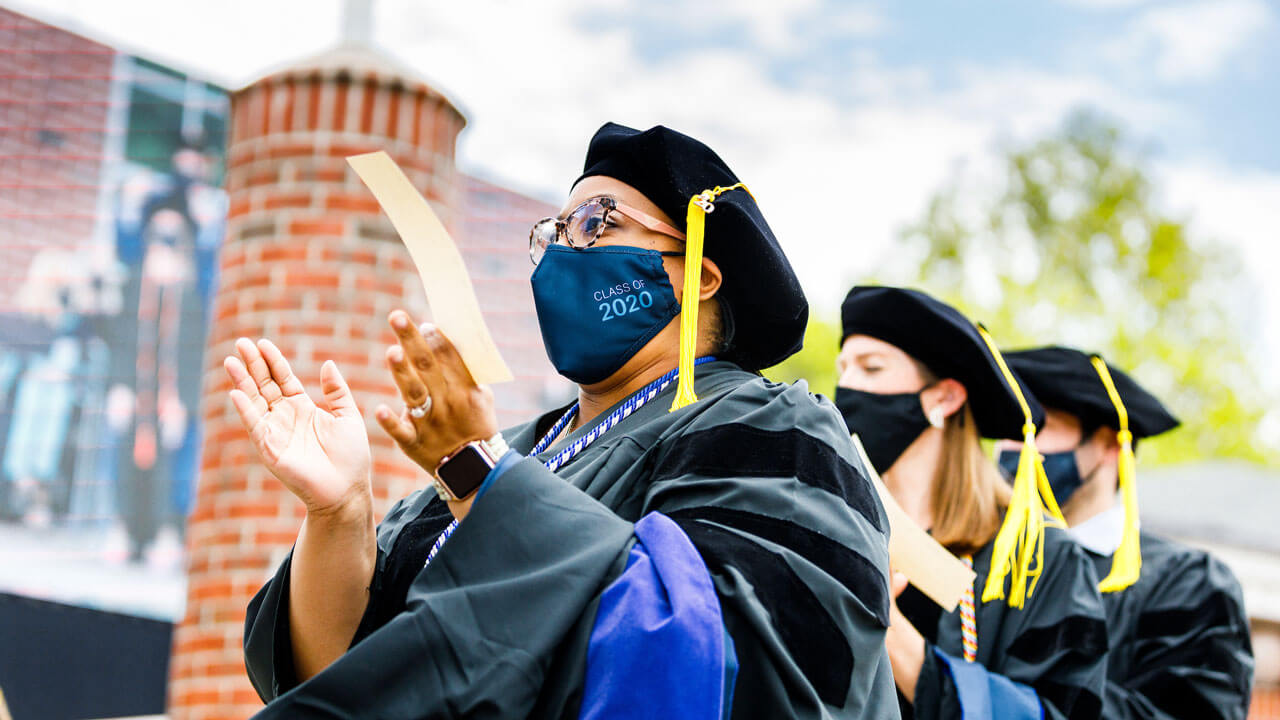Graduate clapping at commencement ceremony