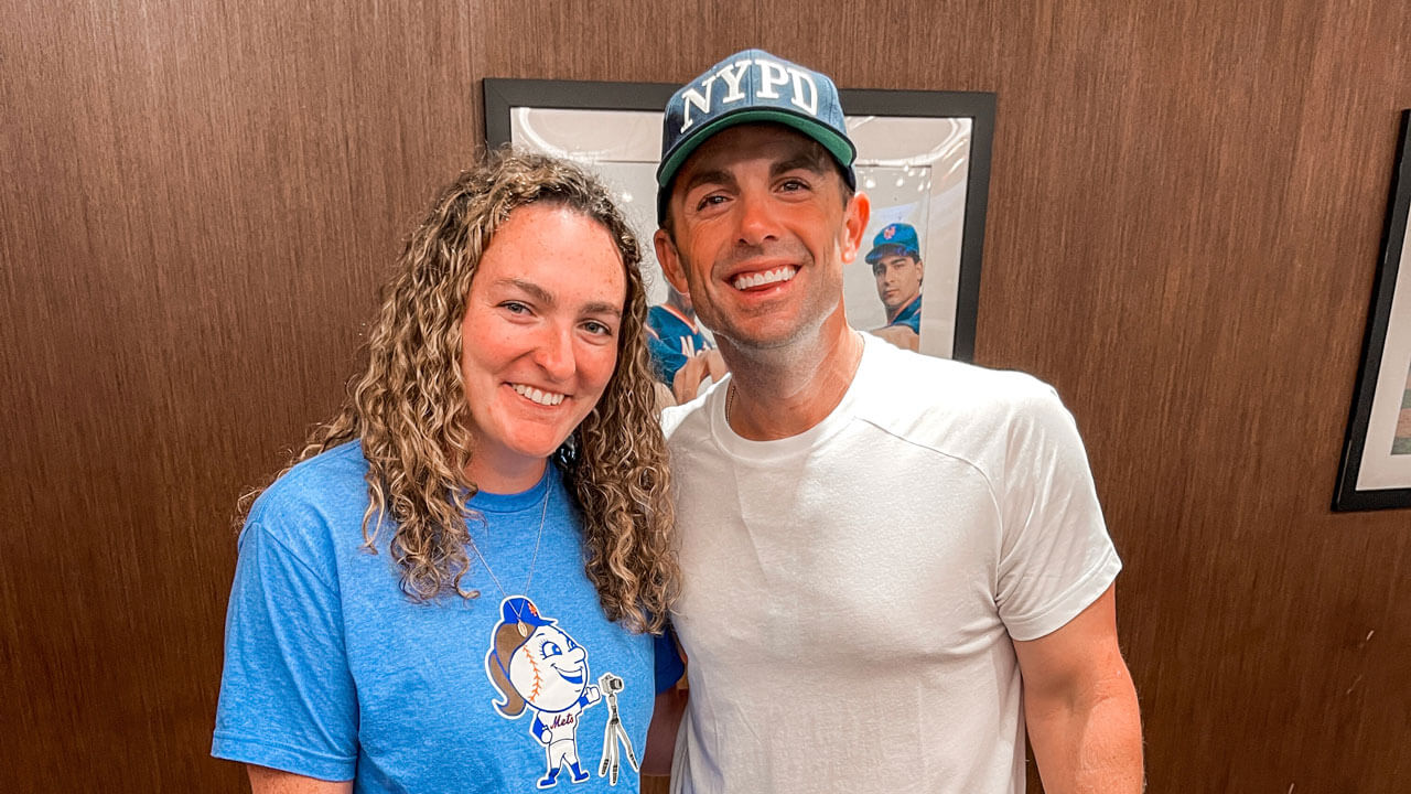 Two individuals smile for a photo.