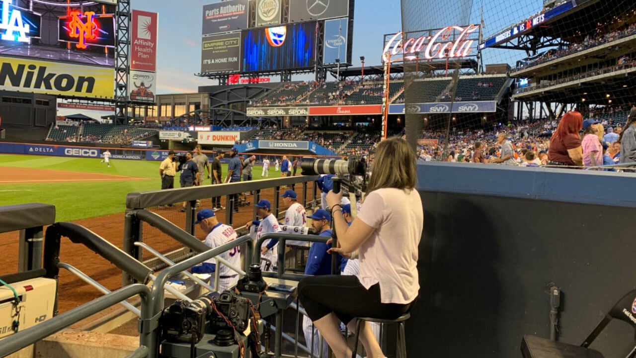 Photographer takes a photo of a baseball stadium during a game.