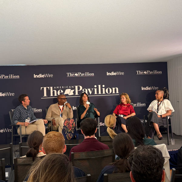 Industry leaders speak on a panel.