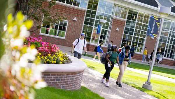 Students walking out from the student center across the quad