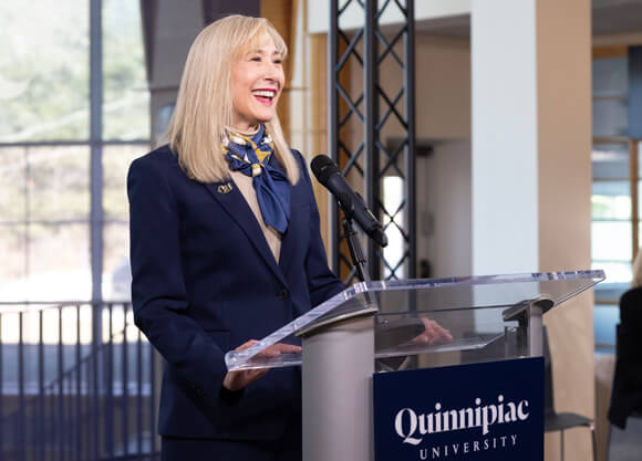 President Hardin speaks at a Quinnipiac University podium