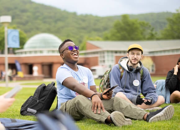 Students sit on the Quad during orientation
