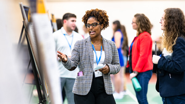 Student presenting their poster