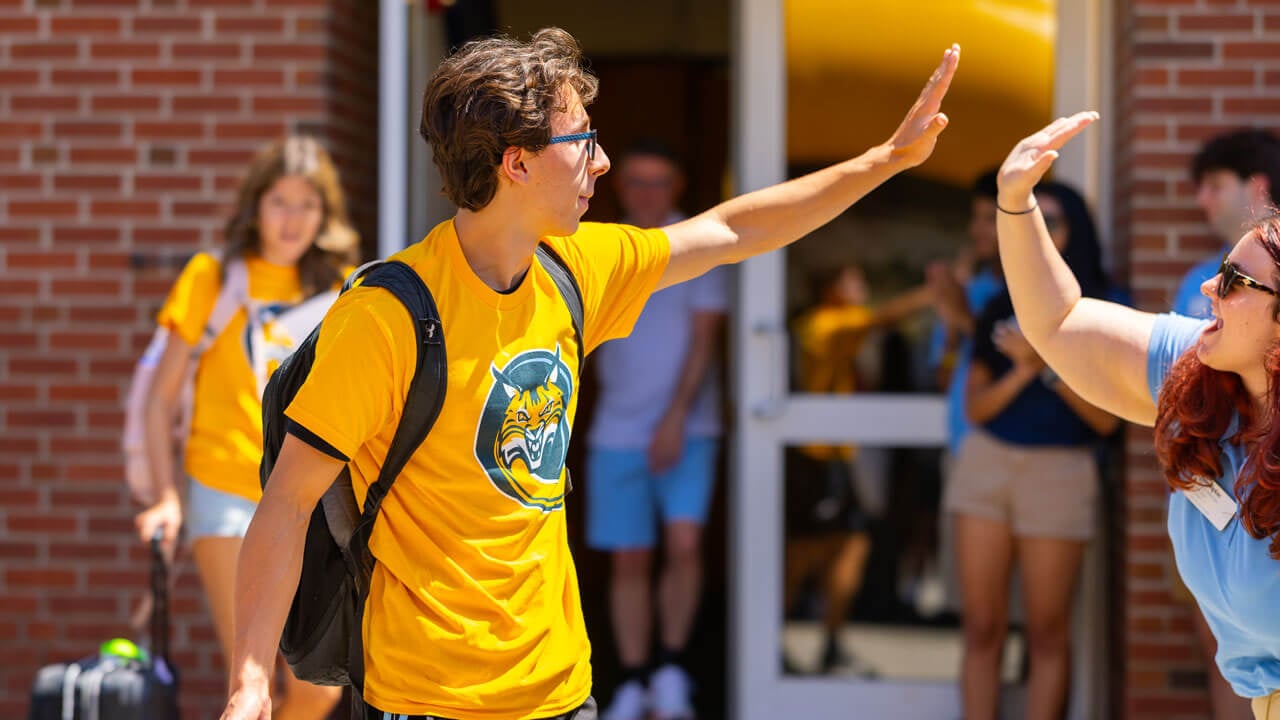 Two individuals high five.