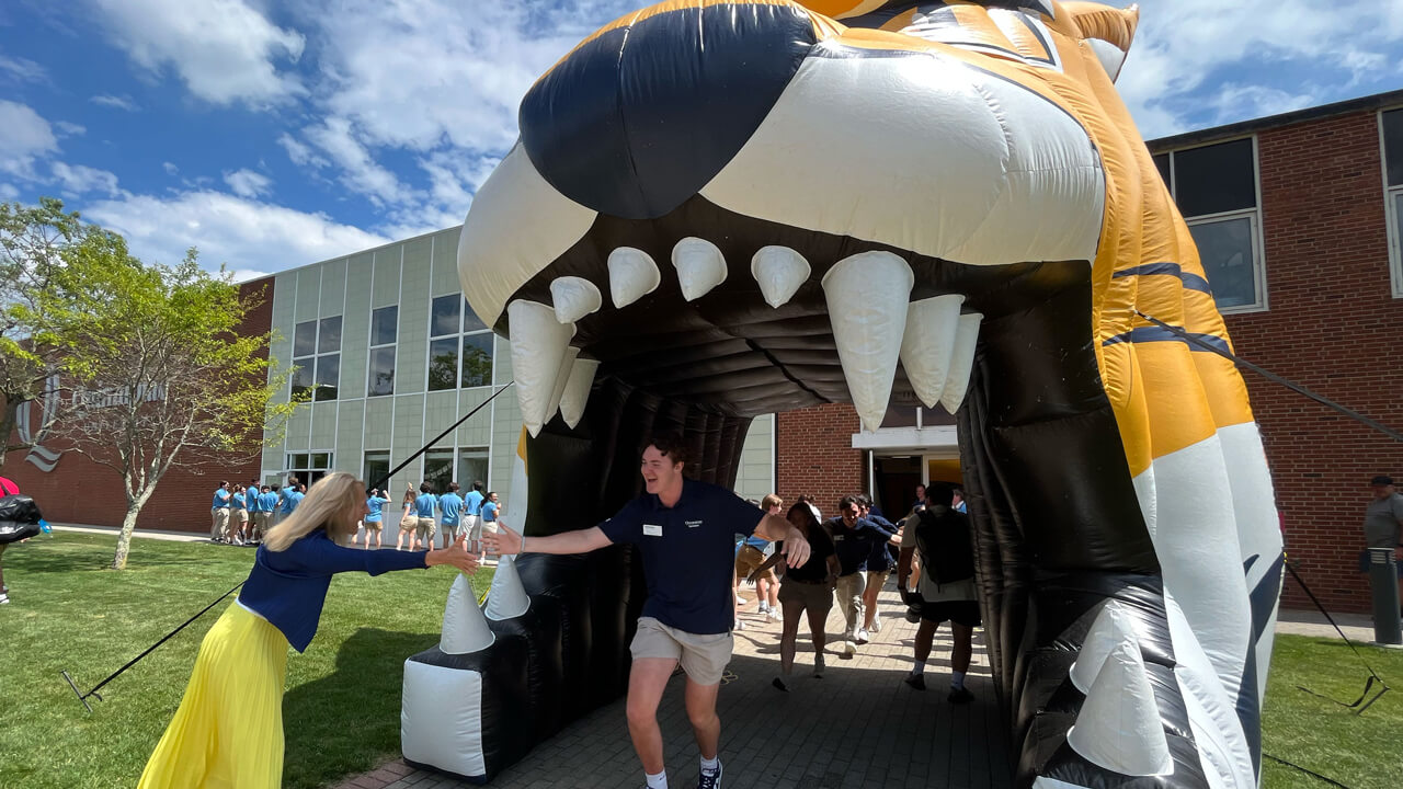 Marie Hardin gives a person a high five in the Bobcat tunnel