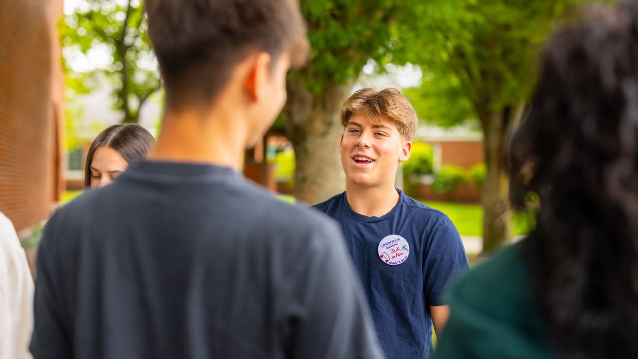 Individuals talking during Orientation