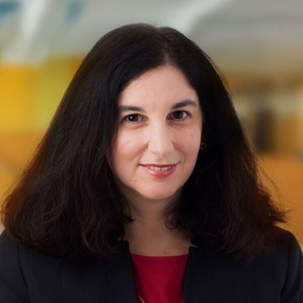 Danielle Gentin smiles against an orange and yellow background