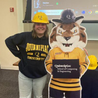 SeSe Allerheiligen in a hard hat posing with Boomer the Bobcat