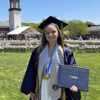 Nichole Gomez with commencement regalia