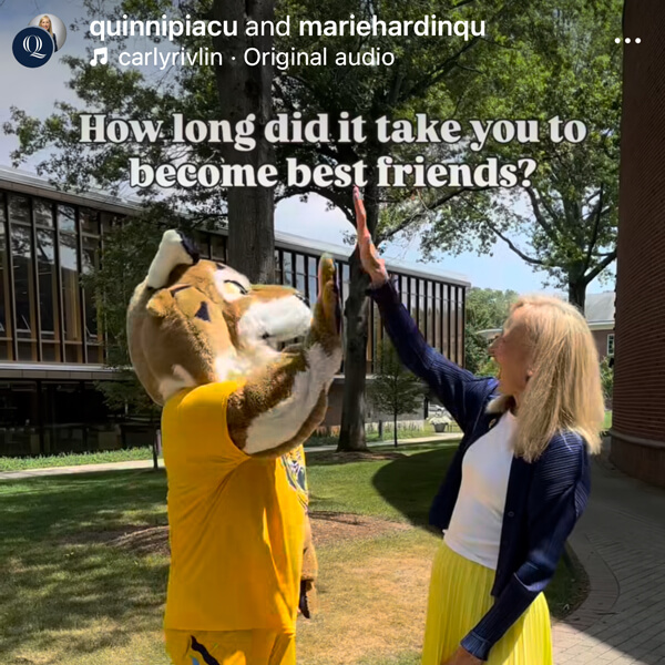 Still of Marie Hardin high fiving Boomer in an Instagram video